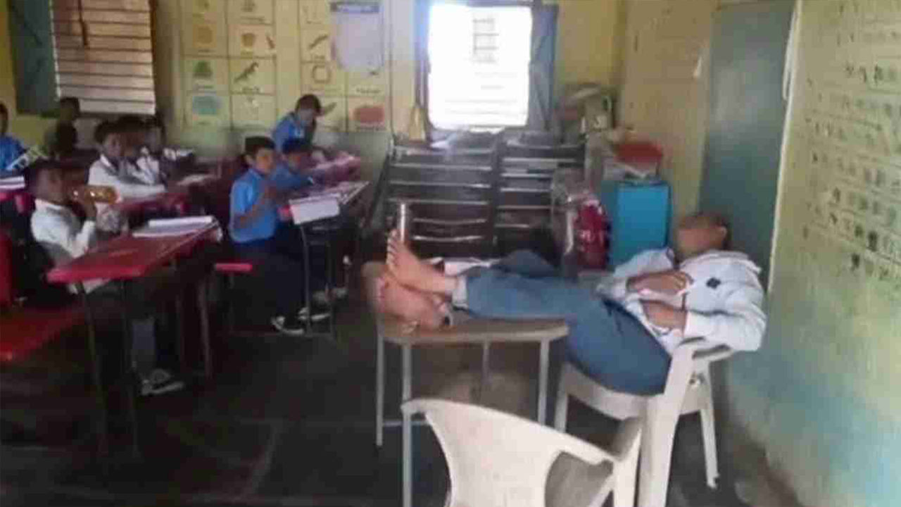 Maharashtra teacher naps in classroom, teacher sleeping during class viral video, teacher snores in classroom Maharashtra, teacher caught sleeping in class Maharashtra, viral video teacher naps in class, teacher sleeping on duty Maharashtra, Maharashtra teacher snores in classroom video, teacher napping during lecture Maharashtra news, teacher caught napping viral video, Maharashtra school teacher sleeping during class, teacher sleeps in classroom for 30 minutes Maharashtra, Maharashtra Teacher Naps Snores For 30 Minutes In Class